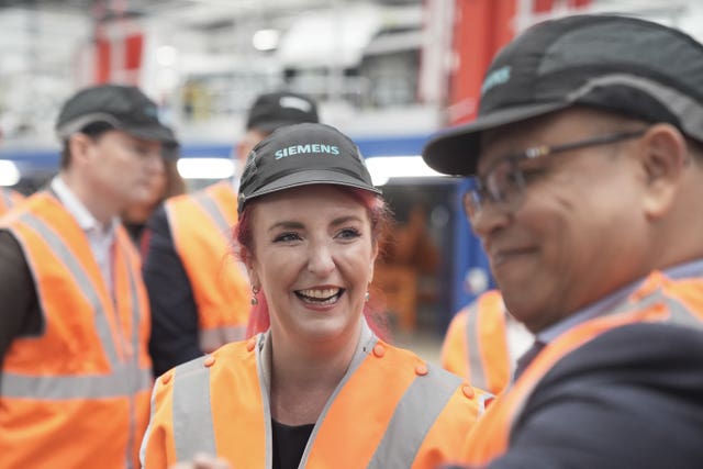 Transport Secretary Louise Haigh smiles while touring a new factory in high-vis clothing