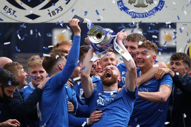 St Johnstone's Shaun Rooney lifts the trophy after the final whistle 