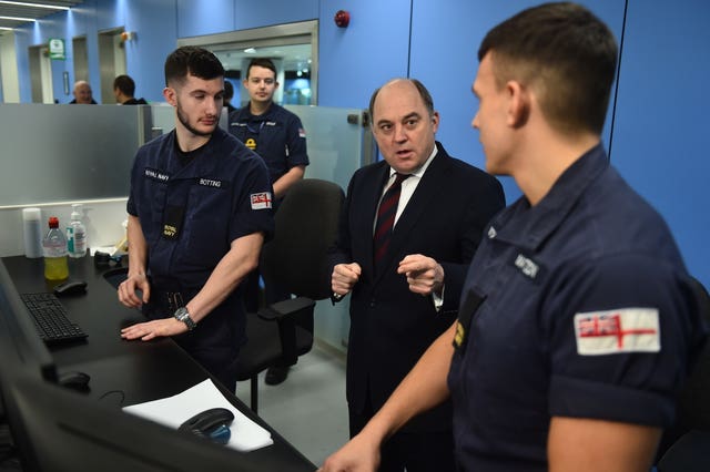 Defence Secretary Ben Wallace meets Royal Navy personnel manning passport control at Manchester Airport