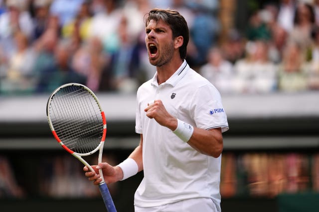 Cameron Norrie celebrates by pumping his fist while shouting