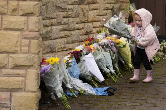 Two-year-old Taya Price leaves flowers outside the home of Ricky Hatton