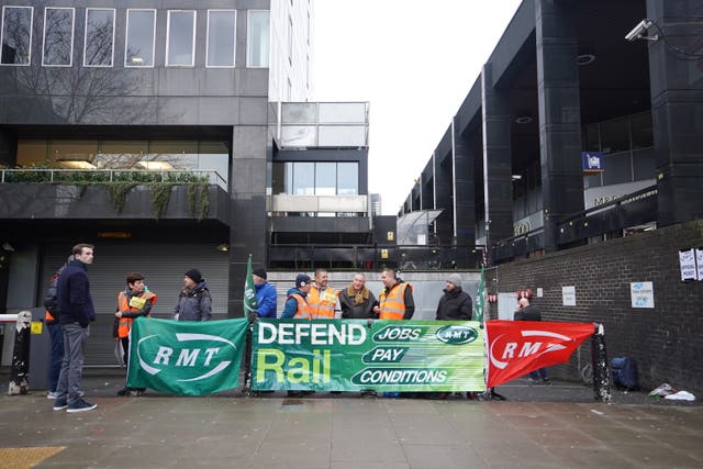 Members of the Rail, Maritime and Transport union on the picket line outside Euston station in London during a rail strike  