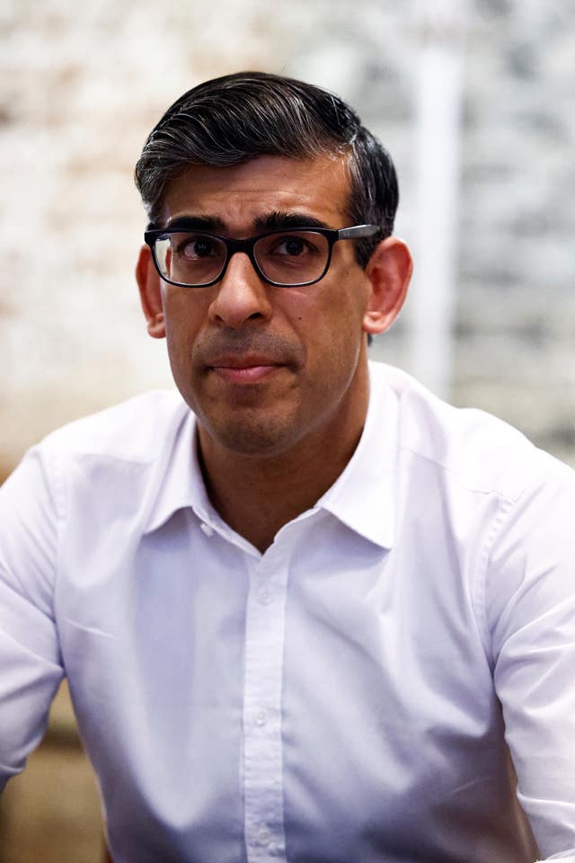 Rishi Sunak, wearing glasses and a white shirt