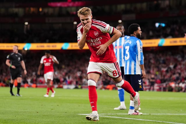Martin Odegaard laughs into his hand as he celebrates scoring Arsenal’s third goal against Coventry