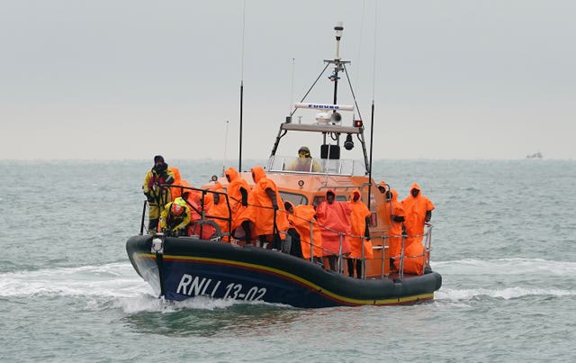 A group of people thought to be migrants are brought in to Dungeness, Kent, after being rescued by the RNLI following a small boat incident in the Channel on Friday