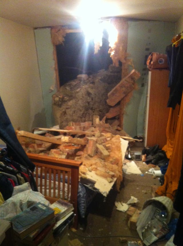 Rubble in a bedroom after a giant boulder fell and smashed through the wall of a home in White Rock, Hastings