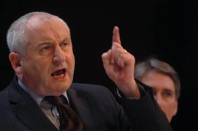 John Bird speaking while waving his finger in the air