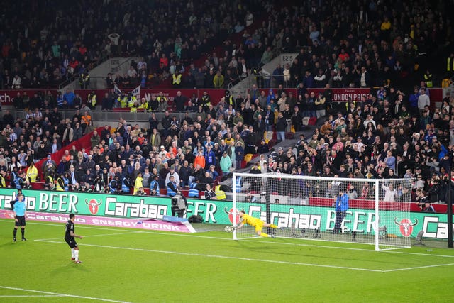 Brentford goalkeeper Mark Flekken, right, saves Liam Palmer's penalty 