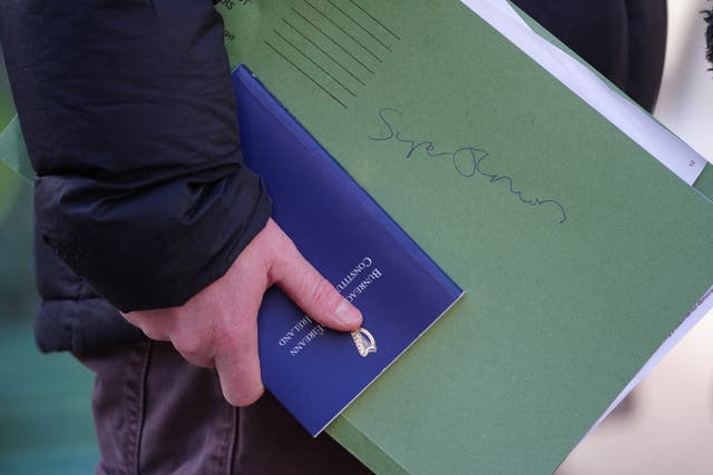 People Before Profit politician Paul Murphy holding a copy of the Constitution of Ireland