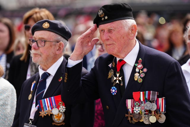 Two World War Two veterans wearing suits jackets covered in medals during a commemoration