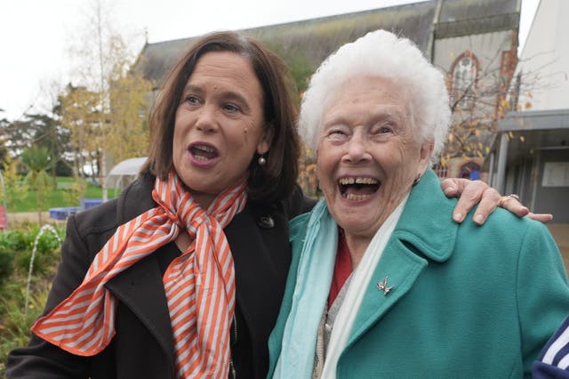 Mary Lou McDonald laughs with an elderly woman