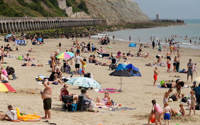 People enjoy the warm weather on the beach in Folkestone, Kent