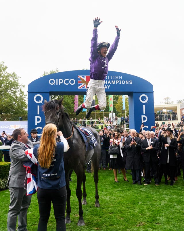 Frankie Dettori jumps off of King Of Steel as he celebrates winning the Qipco Champion Stakes