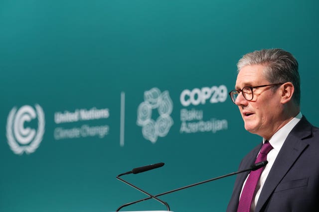 Sir Keir Starmer stands in front of Cop29 signage as he speaks at the UN climate conference 