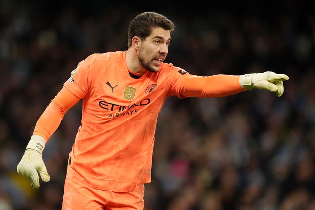 Manchester City goalkeeper Stefan Ortega gestures to a team-mate