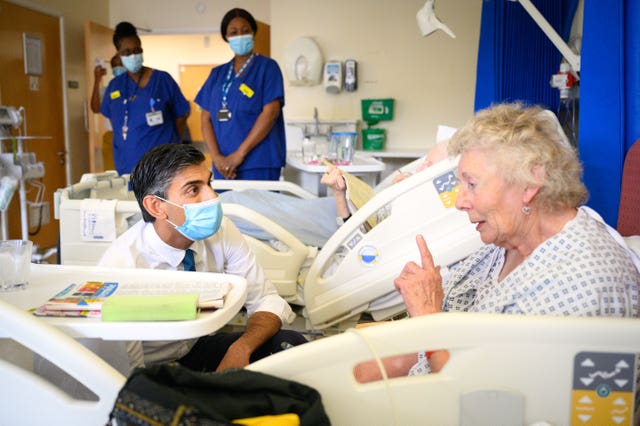 Prime Minister Rishi Sunak speaks with patient Catherine Poole during a visit to Croydon University Hospital last year