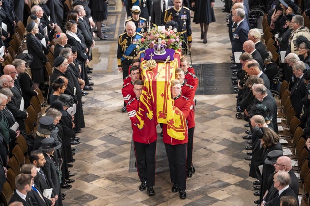 King Charles III, the Queen Consort, the Princess Royal, Vice Admiral Sir Tim Laurence, the Duke of York, the Earl of Wessex, the Countess of Wessex, the Prince of Wales, the Princess of Wales, Prince George, Princess Charlotte, the Duke of Sussex, the Duchess of Sussex, Peter Phillips and the Earl of Snowdon follow behind the coffin of the Queen, draped in the Royal Standard with the Imperial State Crown and the Sovereign’s orb and sceptre, as it is carried out of Westminster Abbey after her state funeral 