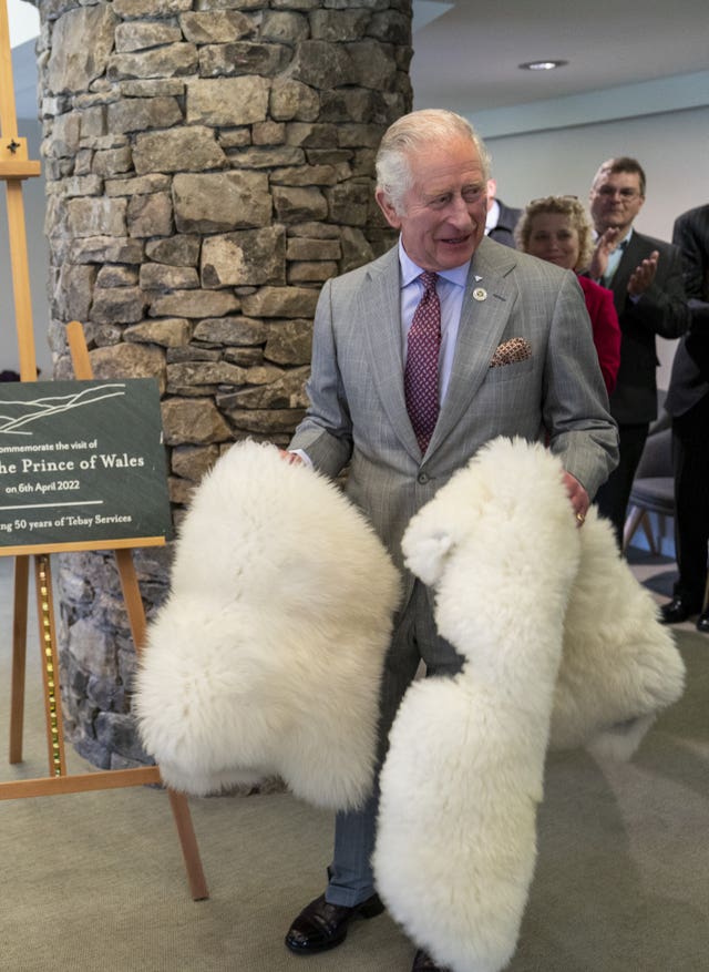 The Prince of Wales unveils a plaque during a visit to Tebay Services in Cumbria to mark its 50th anniversary