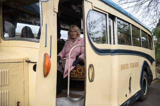 All aboard, Camilla  leaves on a vintage bus after a visit to mark the bicentenary of the birth of Emily Bronte, to The Bronte Parsonage Museum, the former home of the Bronte family, in Haworth, Keighley (Oli Scarff/PA)