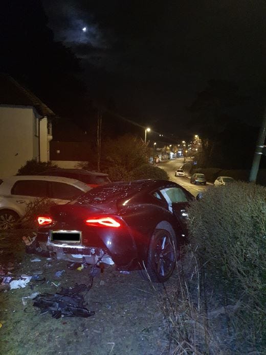 The scene of the collision on Snatts Hill, Limpsfield, with a car sitting halfway through a hedge