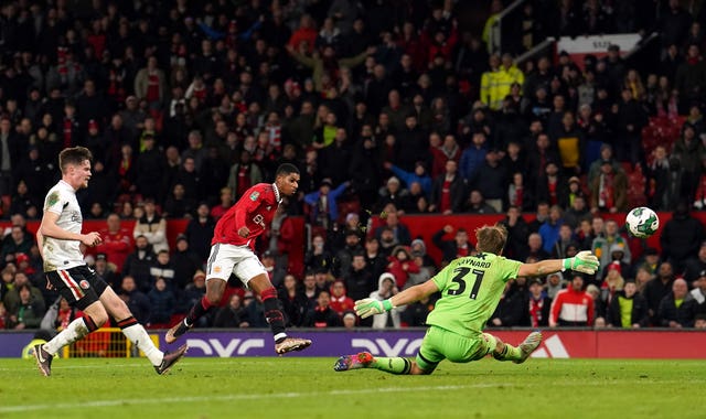 Manchester United’s Marcus Rashford scores their third goal