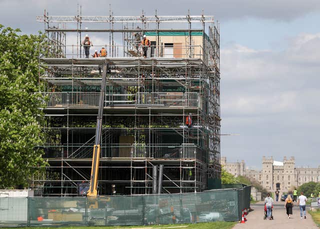Workmen help construct broadcast studios on the Long Walk in Windsor, ahead of the royal wedding (Andrew Matthews/PA)