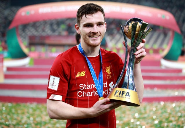 Liverpool's Andy Robertson holding the FIFA Club World Cup trophy