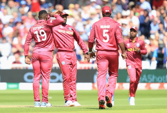 Sheldon Cottrell, left, follows a wicket with his trademark celebration