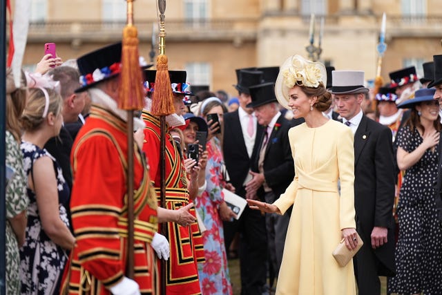 The Princess of Wales talks to guests during a royal garden party at Buckingham Palace 