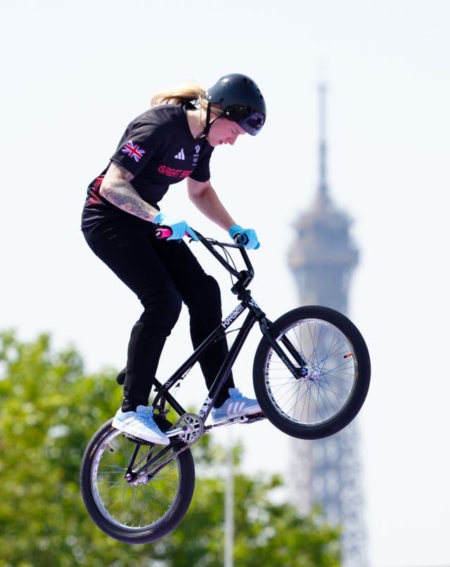 Charlotte Worthington in the air on her BMX with the Eiffel Tower in the background. 