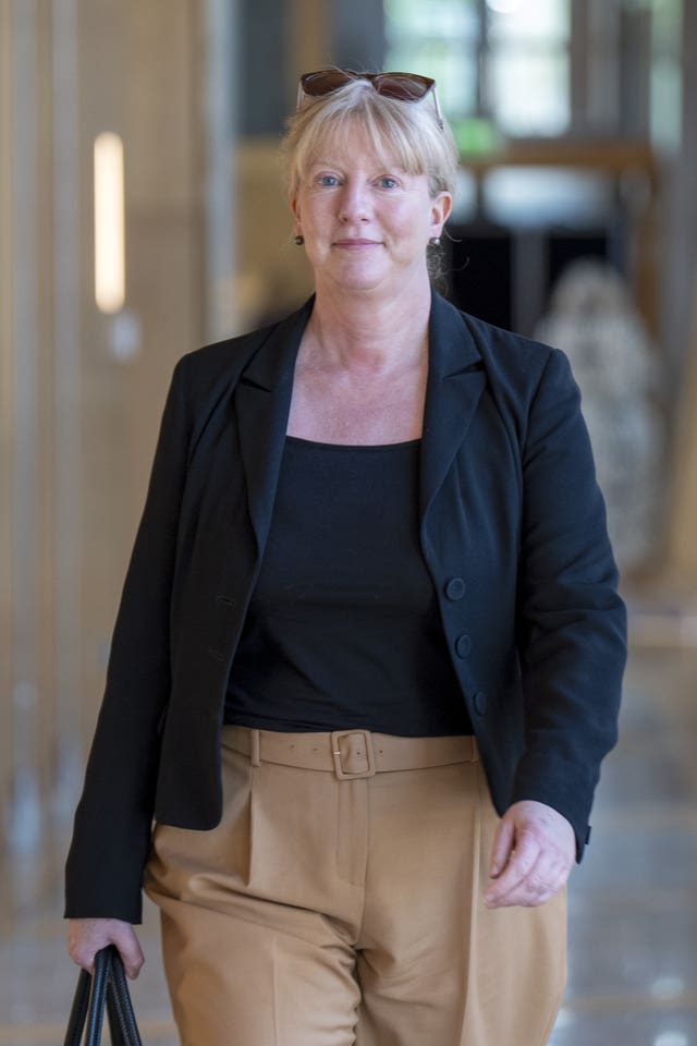 Shona Robison walking through a corridor at Parliament