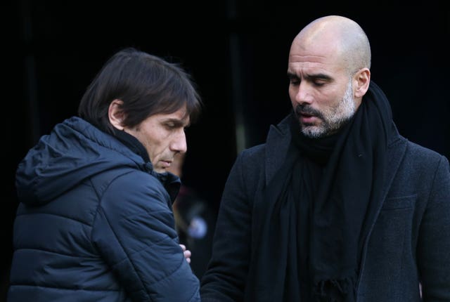 Antonio Conte, left, and Manchester City manager Pep Guardiola shake hands 