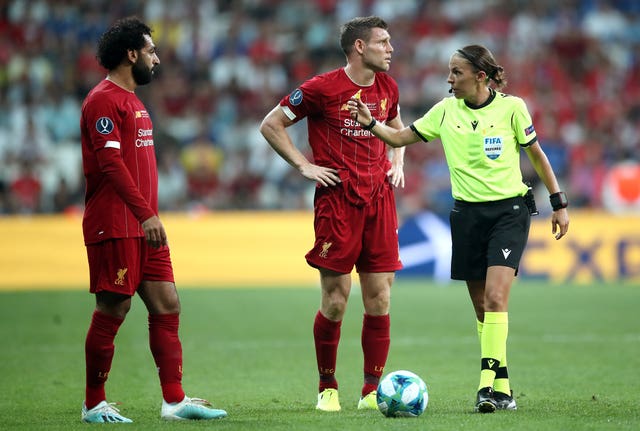 Frappart with Liverpool's Mohamed Salah and James Milner