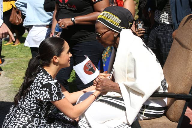 Meghan greeting a member of the community