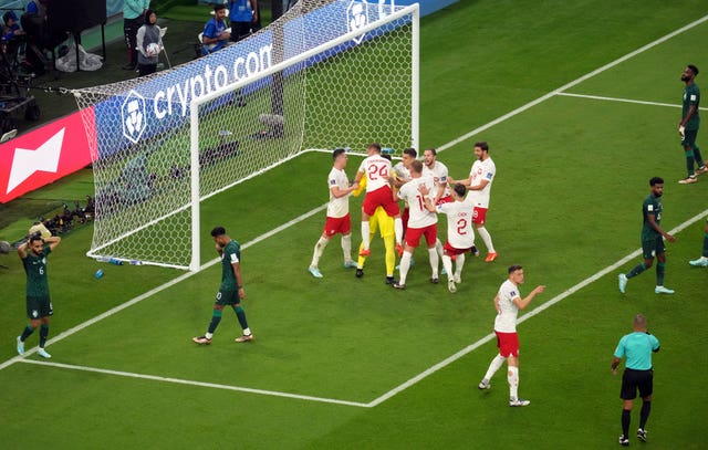 Poland's players mob Szczesny after his double penalty save 