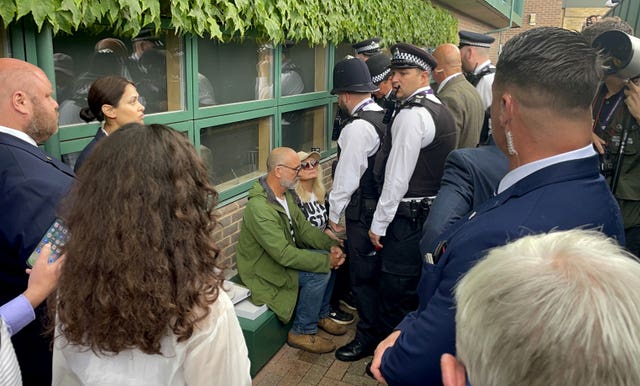 Just Stop Oil protesters are detained by police after throwing orange confetti on Court 18 