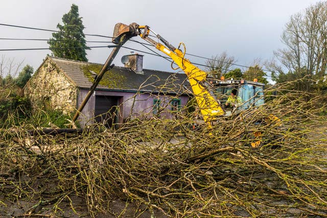 Cork County Council and ESB employees help to clear the road and restore power in Timoleague, West Cork, after Storm Barra hit the UK and Ireland with disruptive winds, heavy rain and snow. Picture date: Tuesday December 7, 2021 