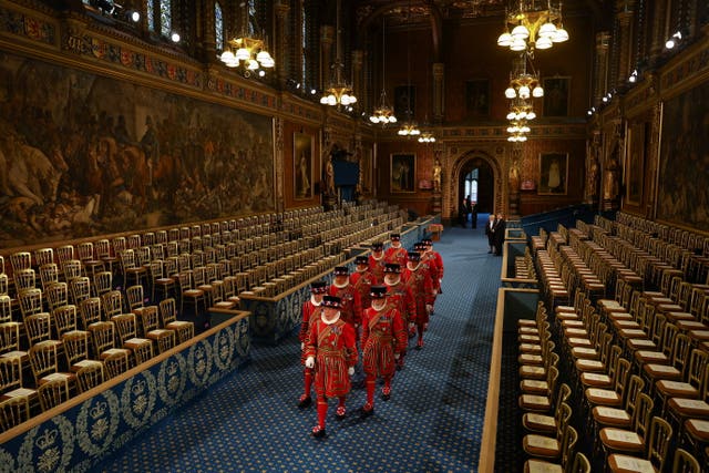 Yeomen of the Guard, wearing traditional uniform, walk through the Royal Gallery during the ceremonial search before the State Opening of Parliament in the House of Lords, London