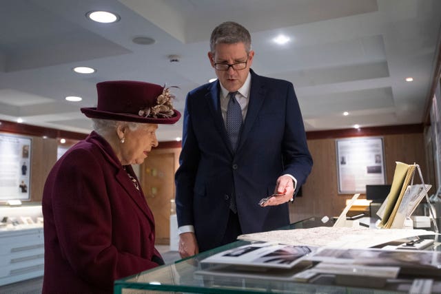 Lord Parker shows the Queen artefacts relating to MI5's D-Day operations during her visit to the intelligence agency. Victoria Jones/PA Wire