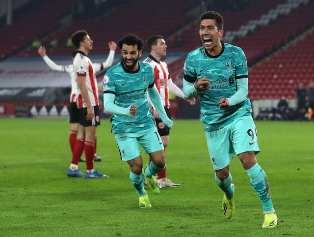 Roberto Firmino celebrates after his deflected shot made it 2-0