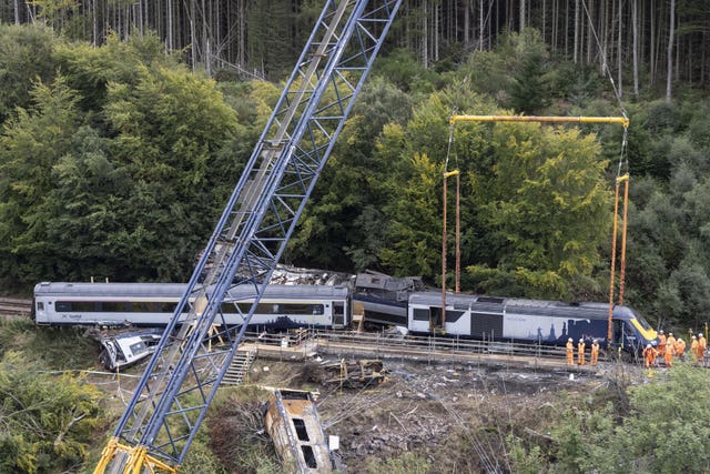 Cranes being used to lift derailed carriages