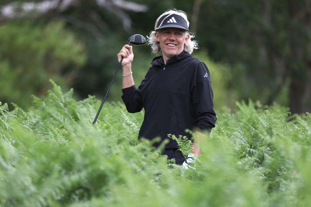 Jimmy Bullard holds a golf club in the rough