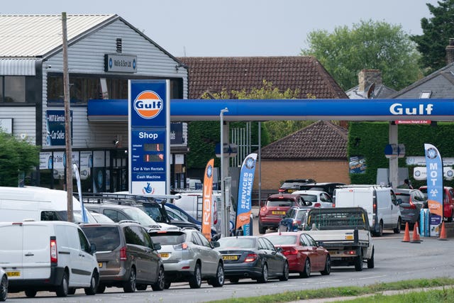 People queue for fuel at a petrol station in Barton, Cambridgeshire