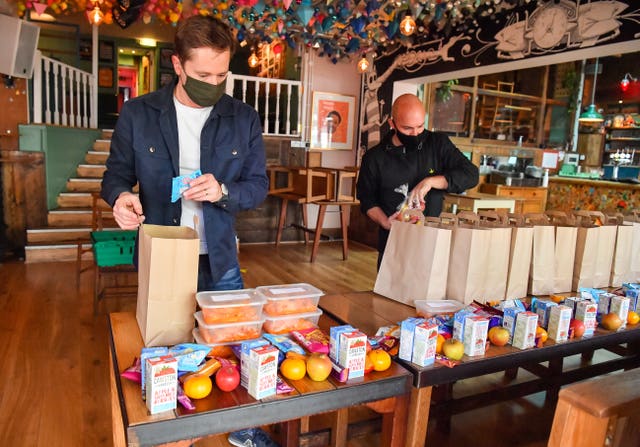 Andy Hope-Johnstone (left) and James Koch prepare free packed lunch bags for delivery at the Gallimaufry pub in Bristol 
