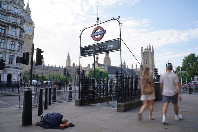 A rough sleeper outside Westminster Tube station in London