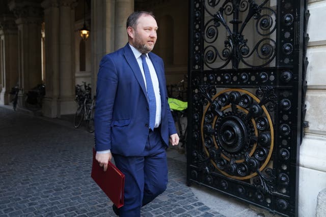 Ian Murray walking outside, carrying his red ministerial folder