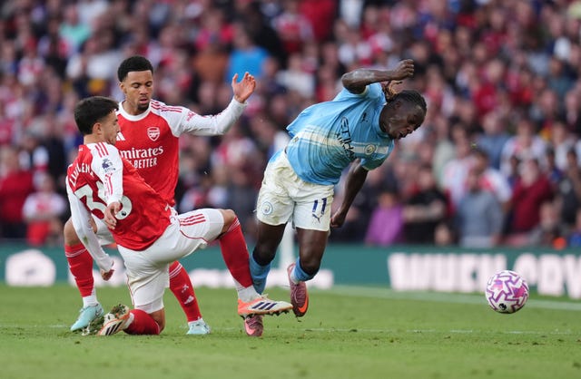 Manchester City’s Jeremy Doku and Arsenal’s Martin Zubimendi battle for the ball