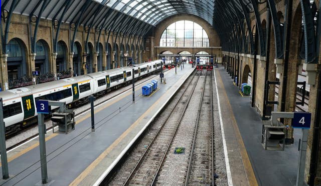 An empty platform and a stationary train at King's Cross station in London