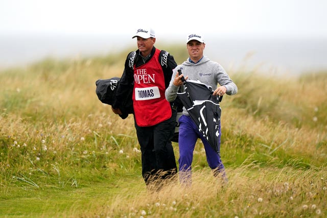 Justin Thomas walks beside caddie Matt Minister