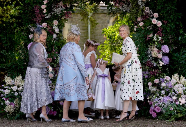 Ali Astall (right) arrives with bridesmaids and guests